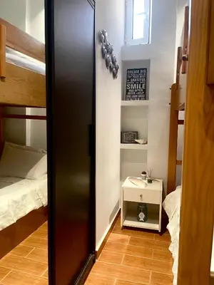 a room with a bedroom with a bed and a mirror at Medusa Apartment in Artemida