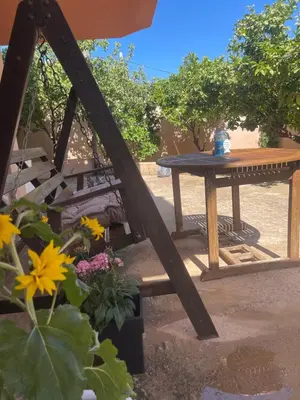 a picnic table and a table and some flowers at Medusa Apartment in Artemida