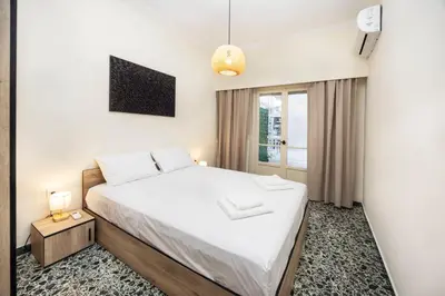 a bedroom with a bed and a window at S37 Acropolis View in Athens