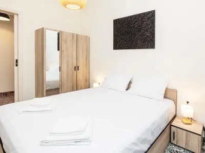 a bedroom with a white bed and a mirror at S37 Acropolis View in Athens