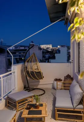 a balcony with chairs and a hammock on a roof at S37 Acropolis View in Athens