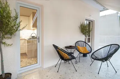 two chairs and a table on a patio at S37 Acropolis View in Athens
