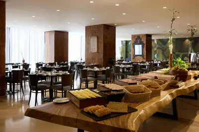 a large dining room with tables and chairs at President Hotel Athens in Athens