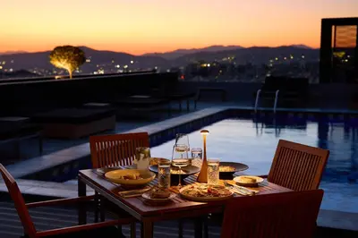 a table with plates of food on top of a balcony at President Hotel Athens in Athens
