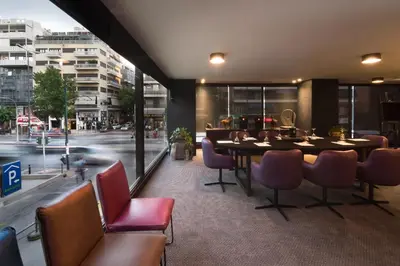 a dining room with a table and chairs and a street at President Hotel Athens in Athens