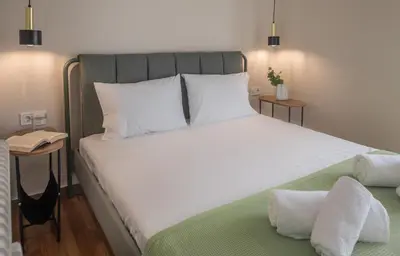 a bedroom with a large bed with white sheets at Wonder Apartment over the Sea in Athens