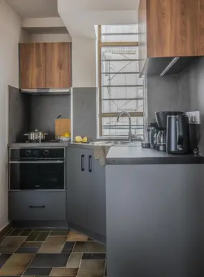 a kitchen with a sink and a stove at Wonder Apartment over the Sea in Athens