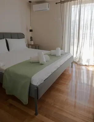 a bedroom with a bed with two pillows on it at Wonder Apartment over the Sea in Athens