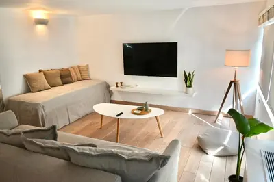 a living room with a couch and a table at Bright and comfy apartment in the heart of Athens in Athens