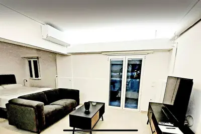 a living room with a couch and a bed at Alimos Cozy Studio in Athens