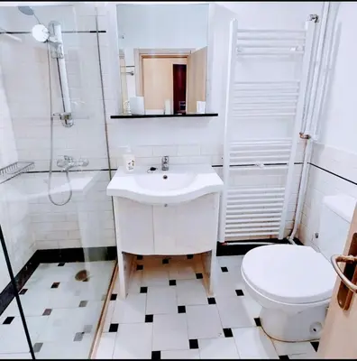 a white bathroom with a sink and a toilet at Alimos Cozy Studio in Athens