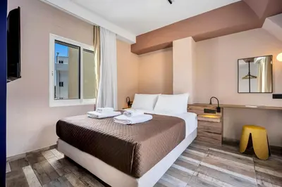 a hotel room with a bed and a television at The Dorians in Athens