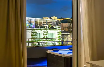 a bathroom with a window with a view of a building at The Dorians in Athens