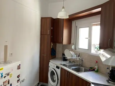 a small kitchen with a sink and a dishwasher at Jenny's Central Apartment in Athens
