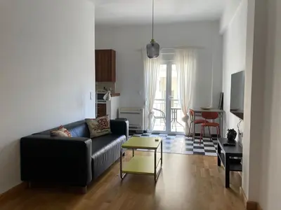 a living room with a couch and a table at Jenny's Central Apartment in Athens