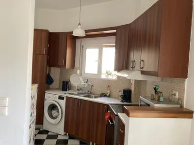 a kitchen with a sink and a washing machine at Jenny's Central Apartment in Athens