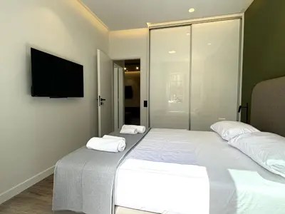 a bedroom with two beds and a tv on the wall at CAS Athens Center Apartments in Athens