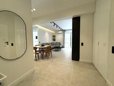 a living room with a mirror and a dining room at CAS Athens Center Apartments in Athens