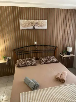 a bedroom with a bed with two pillows on it at George's Apartment in Athens