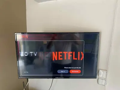 a flat screen tv with the words by me netflix at George's Apartment in Athens