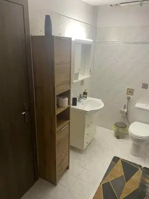 a bathroom with a toilet and a sink at George's Apartment in Athens
