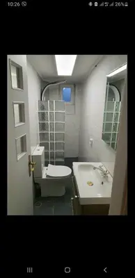 a bathroom with a toilet and a sink at Vouliagmeni Kavouri Beach front in Athens