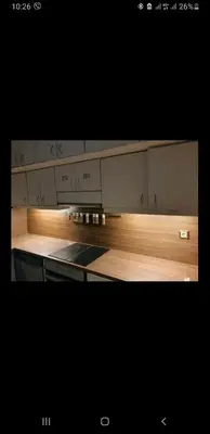 a kitchen with wooden floors and a counter top at Vouliagmeni Kavouri Beach front in Athens