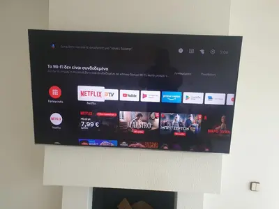 a tv hanging on a wall with a website at Vouliagmeni Kavouri Beach front in Athens