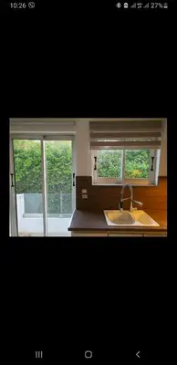 a kitchen with a sink and two windows at Vouliagmeni Kavouri Beach front in Athens