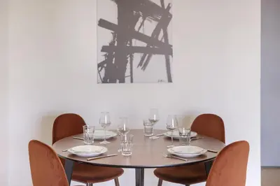 a table with chairs and wine glasses on it at Afroditis58-64 in Athens