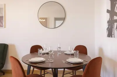 a table with chairs and a mirror in a dining room at Afroditis58-64 in Athens