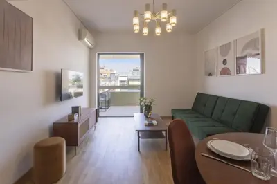 a living room with a green couch and a table at Afroditis58-64 in Athens