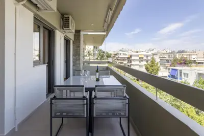 a balcony with a table and two chairs on it at Afroditis58-64 in Athens
