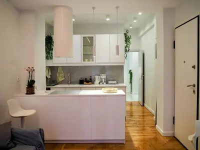 a kitchen with white cabinets and a kitchen island at Athens White House in Athens