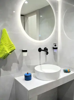 a white bathroom with a sink and a mirror at Athens White House in Athens