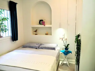 a small bedroom with a bed and a window at Athens White House in Athens