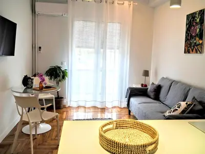 a living room with a couch and a table at Athens White House in Athens