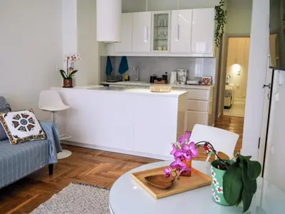 a kitchen and a living room with a table at Athens White House in Athens