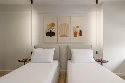 two beds sitting next to each other in a room at Acropolis View Plunge Pool Loft in Athens