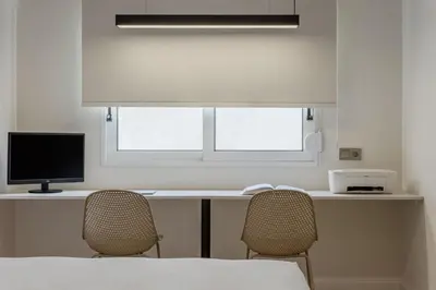 a room with a desk with a computer and two chairs at Acropolis View Plunge Pool Loft in Athens