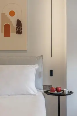 a bed with a table with two apples on it at Acropolis View Plunge Pool Loft in Athens
