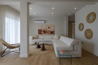 a living room with a white couch and a chair at Acropolis View Plunge Pool Loft in Athens