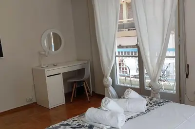 a bedroom with a bed with a desk and a window at Dalia Apartment- 3 BD,1 BATH in Athens