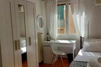 a bedroom with a desk and a bed and a window at Dalia Apartment- 3 BD,1 BATH in Athens