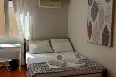 a bed with towels on it in a room at Dalia Apartment- 3 BD,1 BATH in Athens