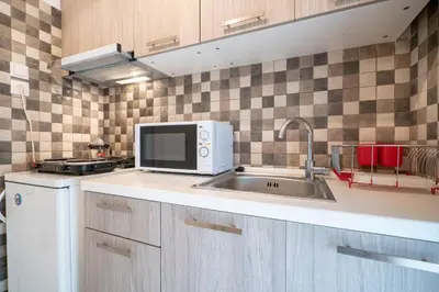 a kitchen with a sink and a microwave at City Link Gyzi by MPS in Athens