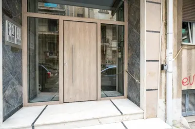 a wooden door on the side of a building at City Link Gyzi by MPS in Athens