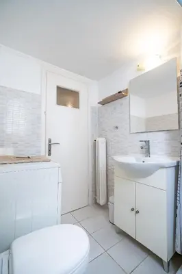 a white bathroom with a toilet and a sink at City Link Gyzi by MPS in Athens