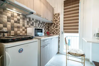 a kitchen with a stove and a microwave at City Link Gyzi by MPS in Athens