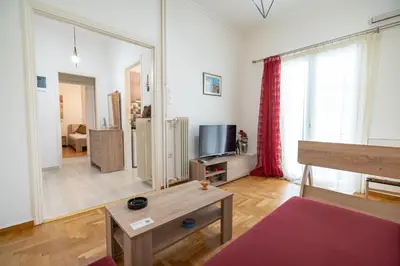 a living room with a couch and a tv at City Link Gyzi by MPS in Athens